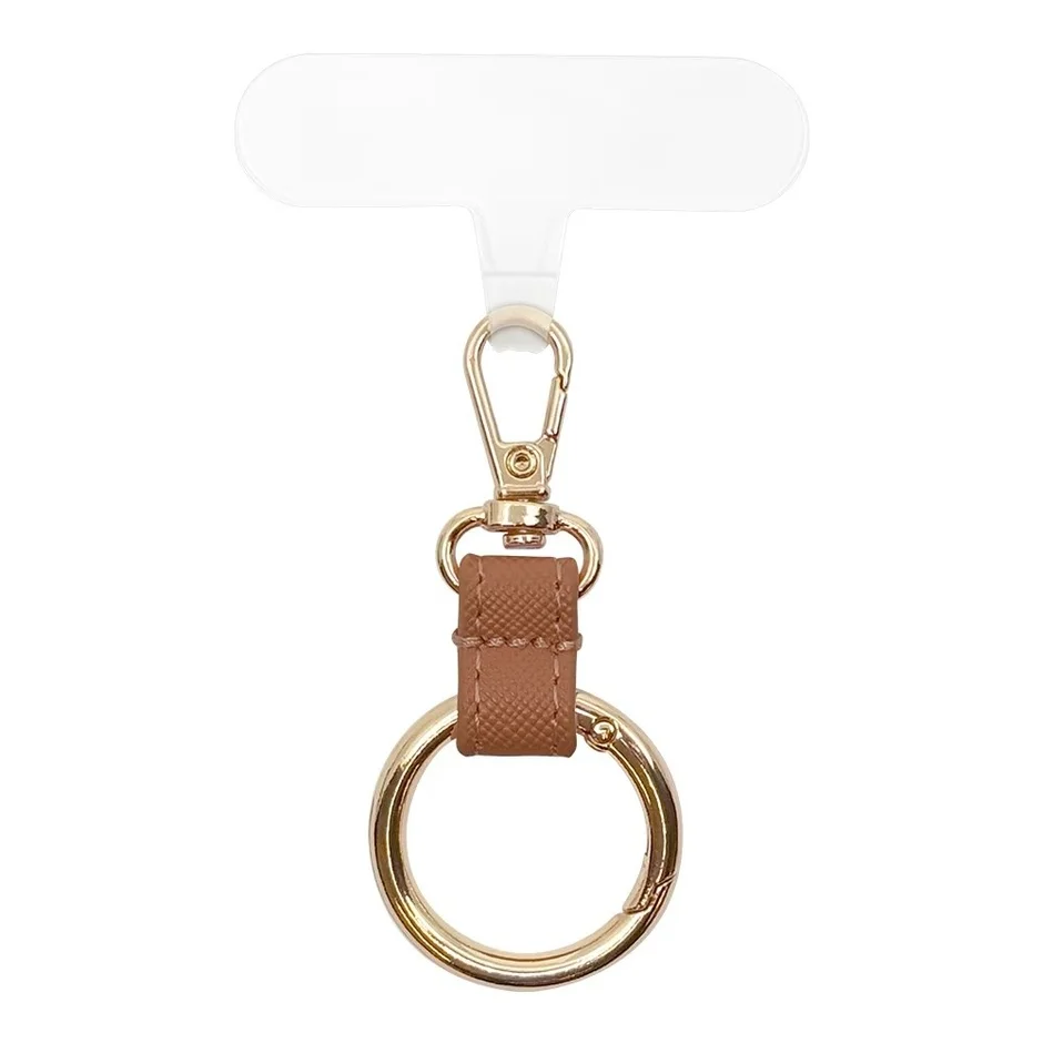 スマートフォンケースに取り付けて使用するブラウンのレザー調ストラップホルダー。ゴールドのカラビナと大きなリングが特徴で、キーホルダーとしても使えるファッション小物です。